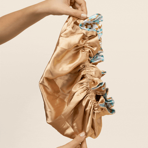 Bounce Curl reversible satin hair bonnet for smooth, frizz-free curls with adjustable fit